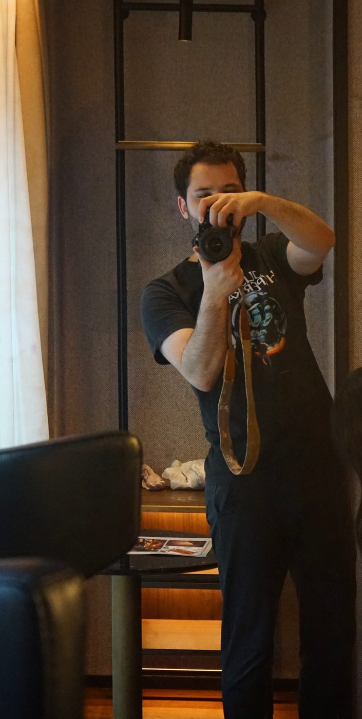 Self-portrait in a hotel mirror, camera raised to the eye